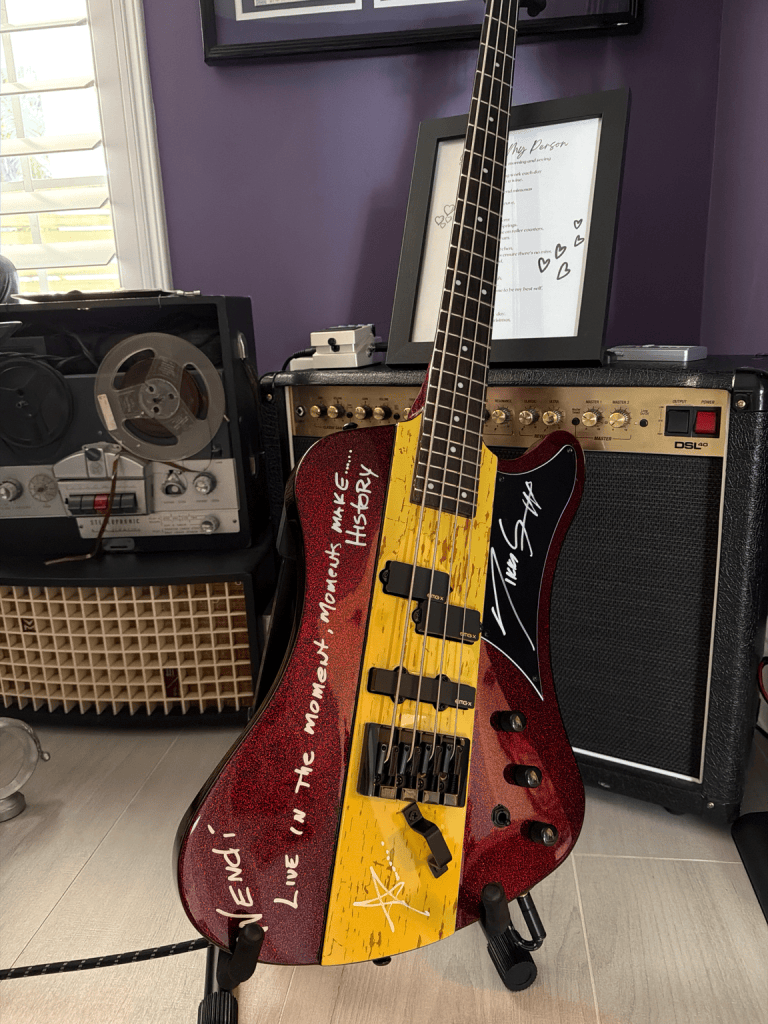 Bass guitar signed by Nikki Sixx displayed in Wendi and Dan’s music room.