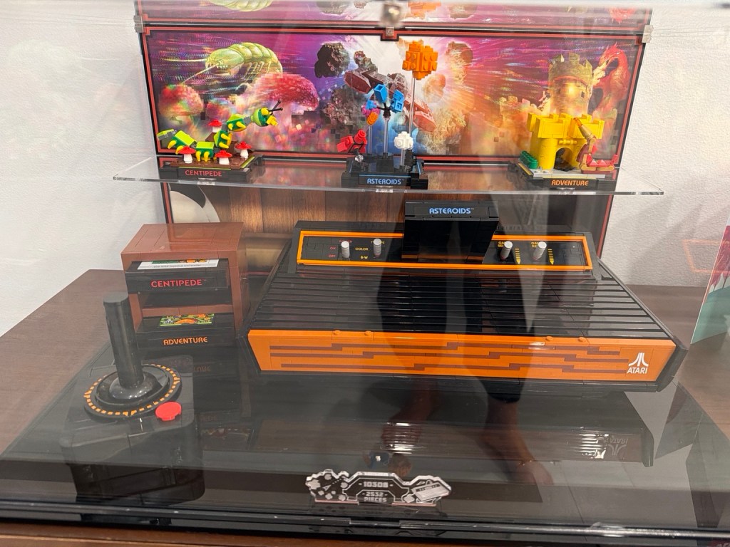 LEGO replica of a classic Atari 2600 console with joystick, game cartridges and brick-built scenes from vintage Atari games.