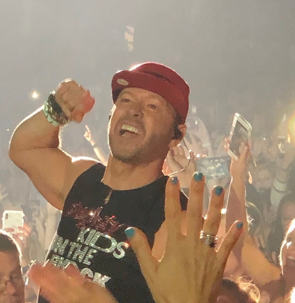 New Kids on the Block performer interacting with fans during a live concert.