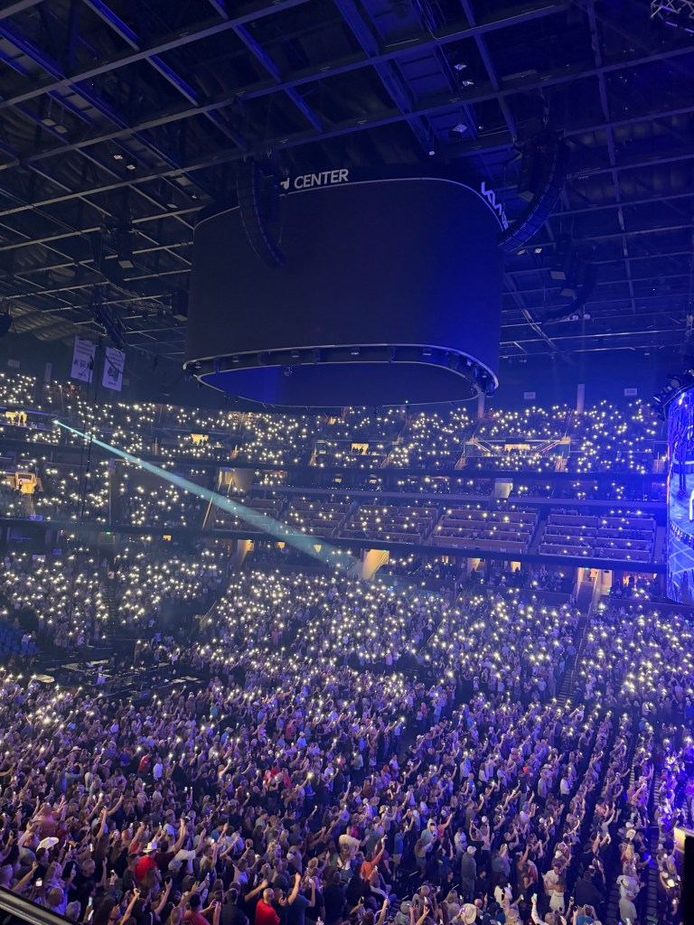 Arena filled with thousands of illuminated phone lights during Garth Brooks’ concert.