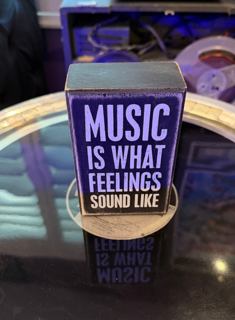 Sign in Wendi and Dan’s home reading “Music is what feelings sound like.”